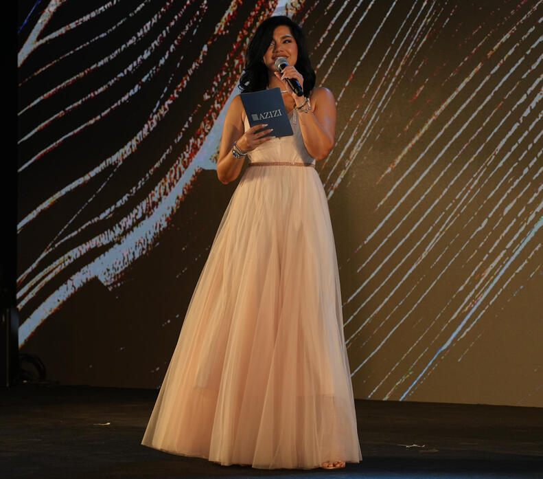 MC Dija on stage at Azizi Development Annual Gala alt="MC Dija hosting Azizi Developments event in Dubai"